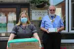 Willie Fraser, President of the Rotary Club of Dunmow, presenting the 1,000 facemasks to the Redbond Care Home manager Sam Dearlove.
